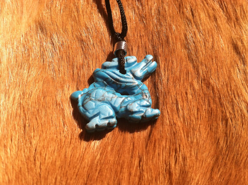 Carved stone dragon necklace.  Made of turquoise.