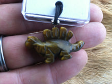 Load image into Gallery viewer, Carved stone dinosaur necklace.  Made of Tiger Eye