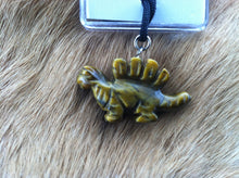 Load image into Gallery viewer, Carved stone dinosaur necklace.  Made of Tiger Eye