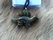 Load image into Gallery viewer, Carved stone dinosaur necklace.  Made of Tiger Eye