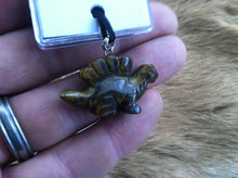 Load image into Gallery viewer, Carved stone dinosaur necklace.  Made of Tiger Eye