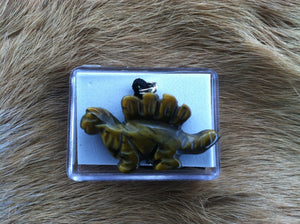 Carved stone dinosaur necklace.  Made of Tiger Eye